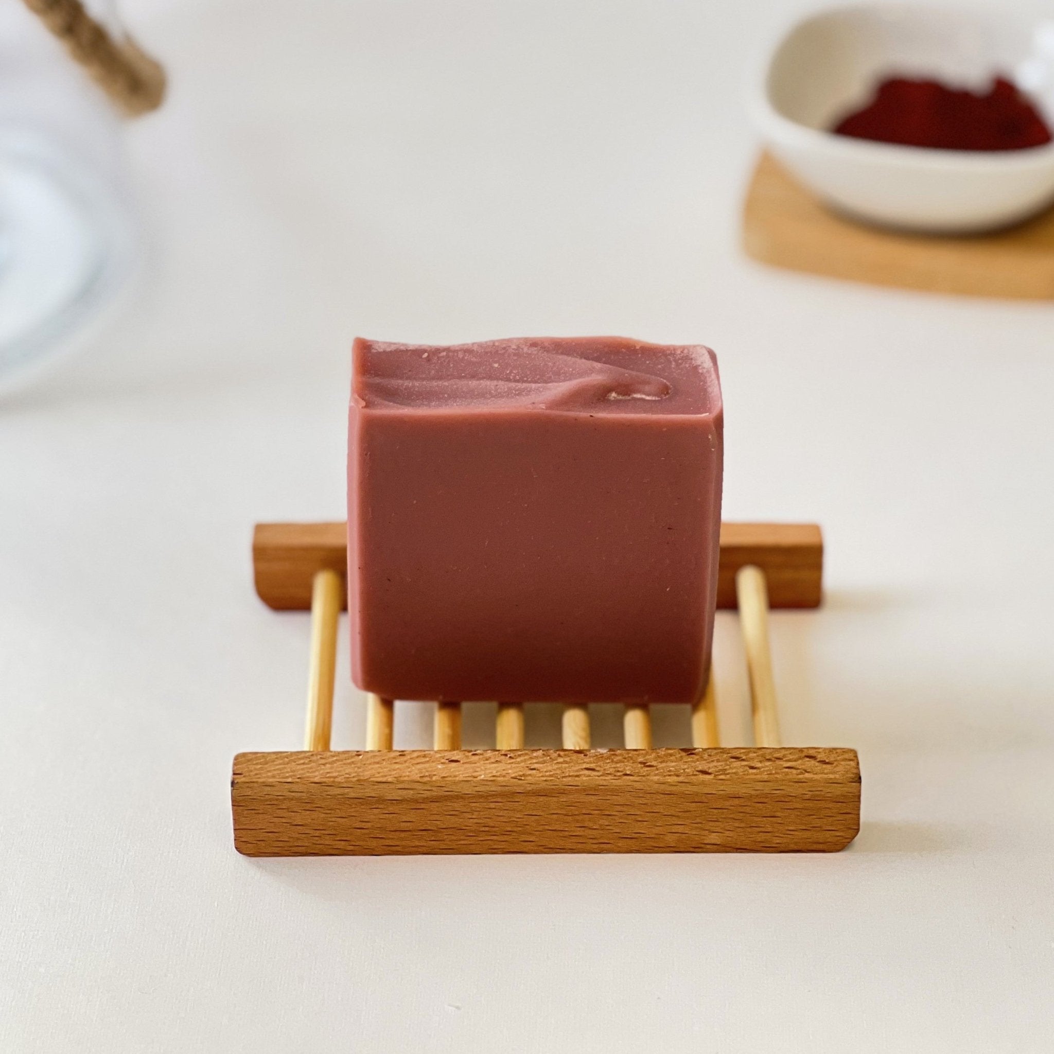 Nuada Naturals Amber Earth clay soap bar sitting on a wooden tray