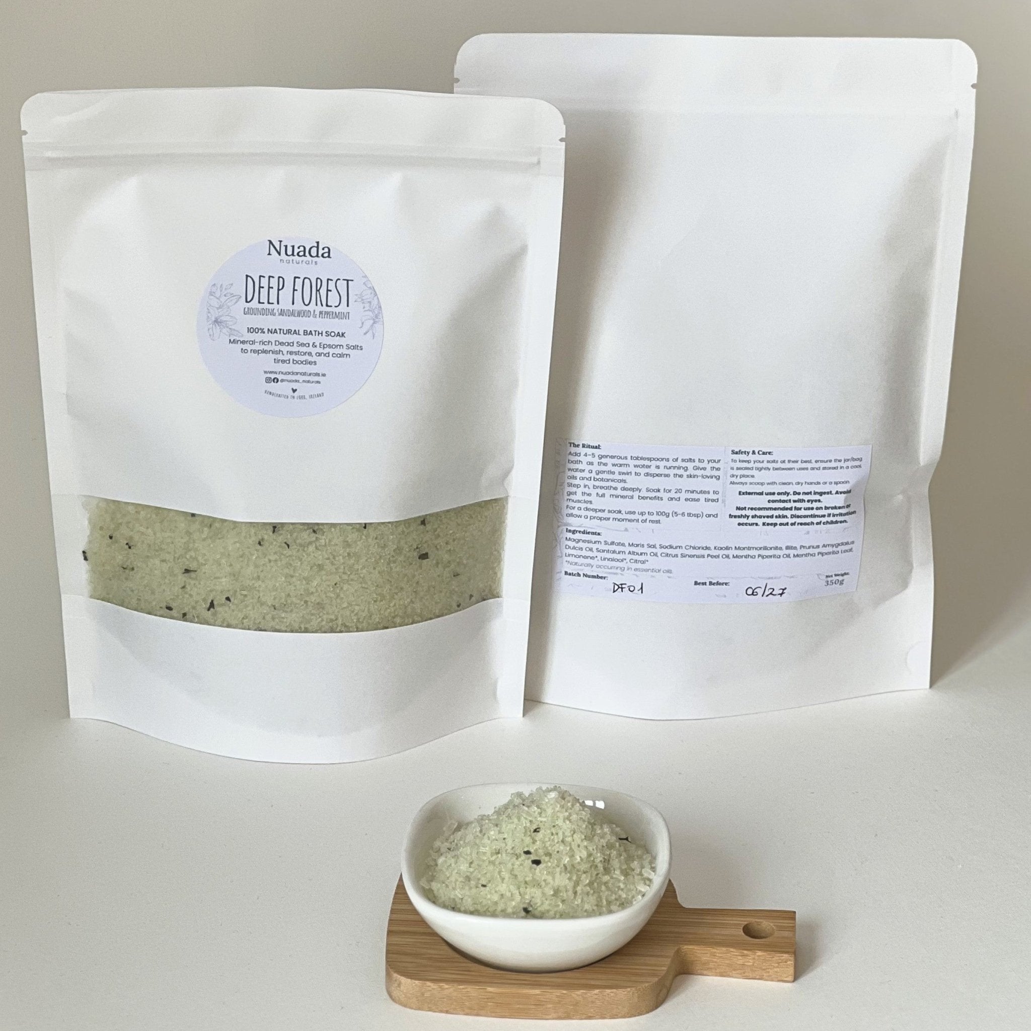 Nuada Naturals Deep Forest sandalwood and peppermint bath soak pouch set on wooden tray