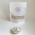 Nuada Naturals Dusk bath soak pouch with small ceramic dish of herbal bath salts