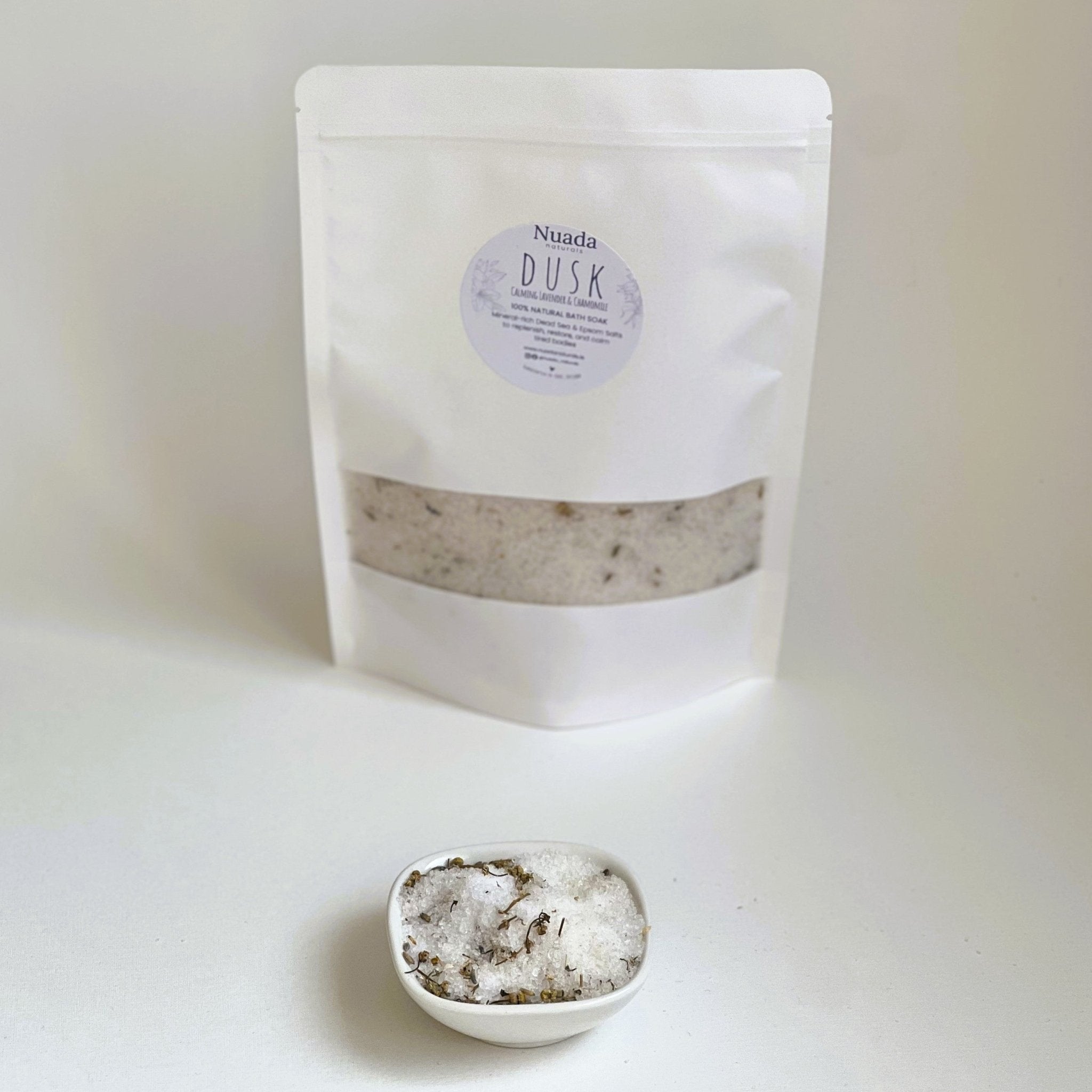 Nuada Naturals Dusk bath soak pouch with small ceramic dish of herbal bath salts