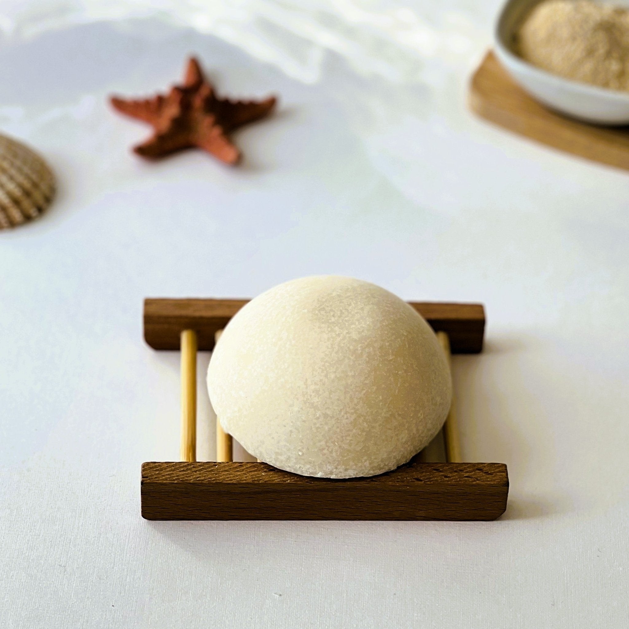 Nuada Naturals Golden Shore dome sea salt soap bar resting on a wooden tray