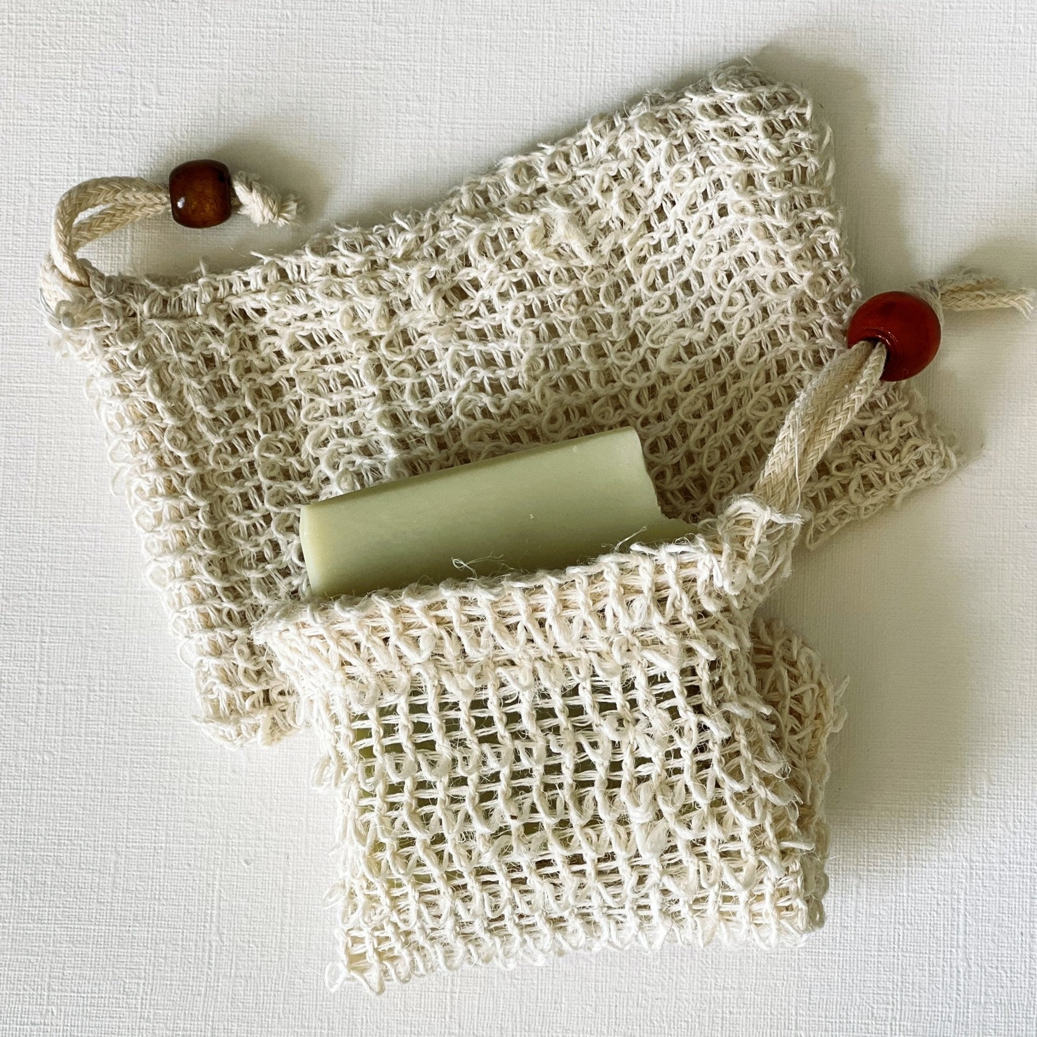 Nuada Naturals natural soap bar inside textured sisal exfoliating pouch