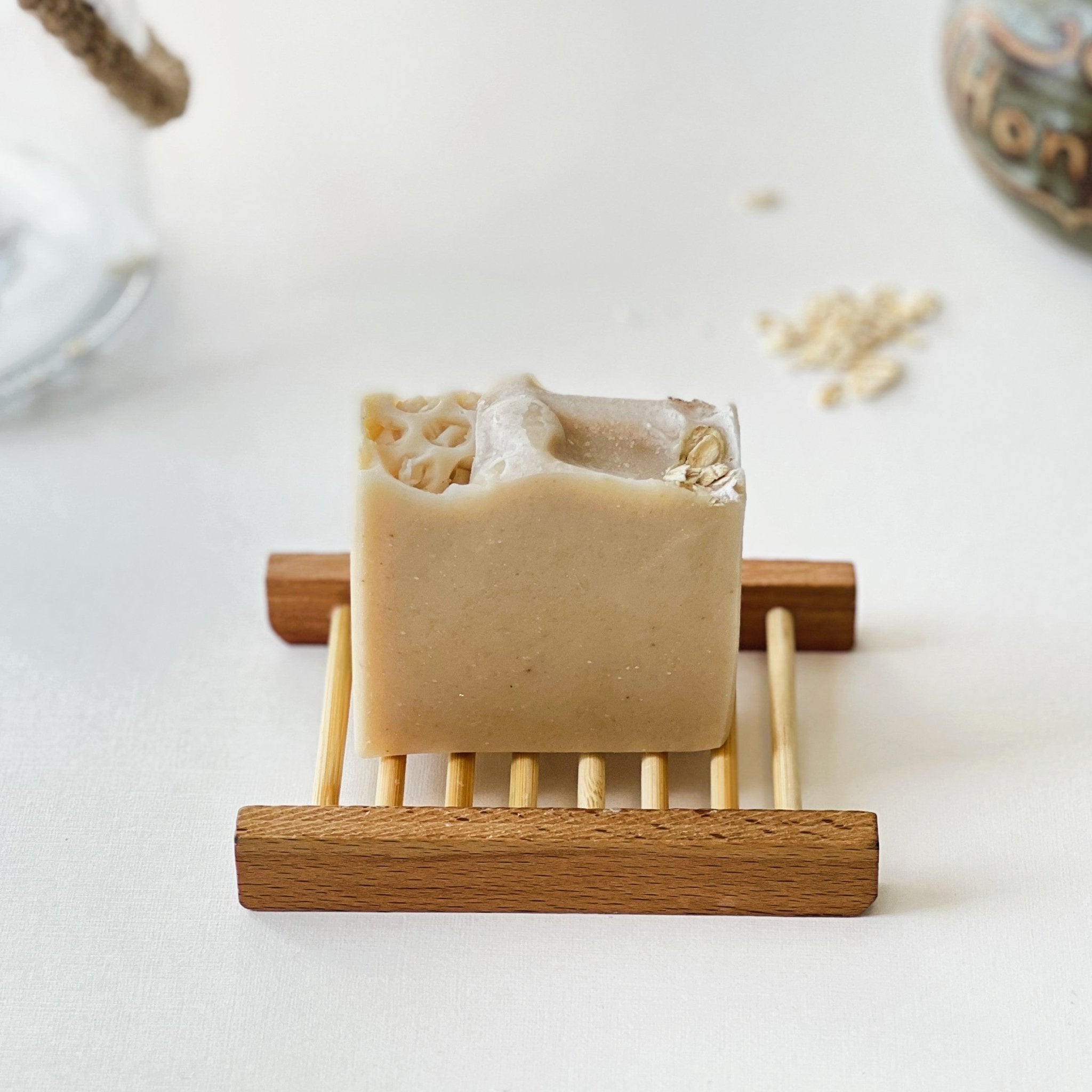 Nuada Naturals Mo Chara oatmeal soap bar with honeycomb top on wooden tray