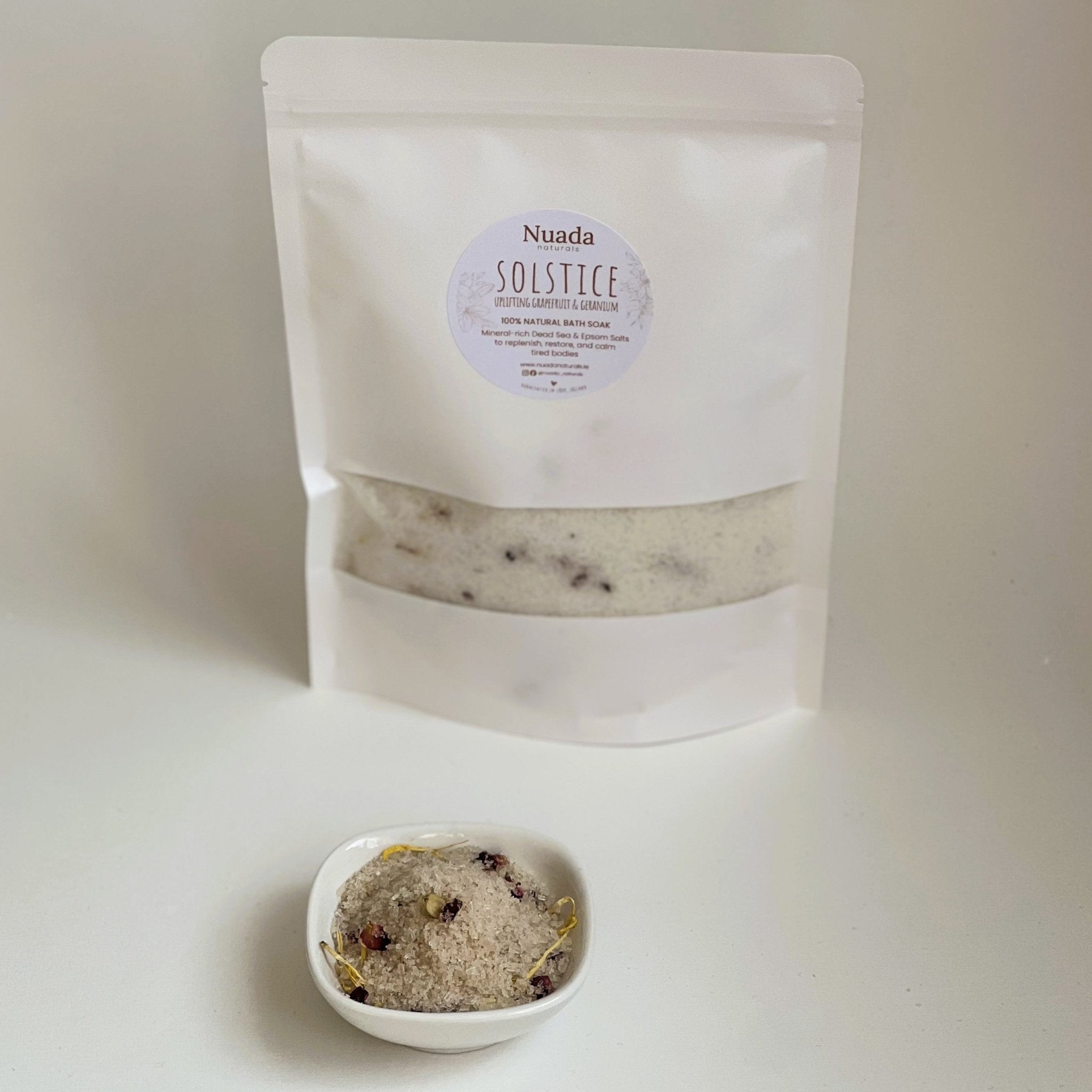 Nuada Naturals Solstice bath soak pouch with small ceramic dish of bath salts